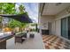Covered patio with outdoor table and umbrella-covered seating area for relaxing at 18504 Country Crest Pl, Tampa, FL 33647