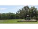Community playground with play structure on a large grassy field, perfect for outdoor fun and recreation at 18504 Country Crest Pl, Tampa, FL 33647