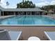 Community swimming pool featuring a long lane area, lounge chairs, and well-maintained grounds at 18504 Country Crest Pl, Tampa, FL 33647
