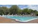 Large community swimming pool with crystal blue water, lounge seating, and well-kept surroundings at 18504 Country Crest Pl, Tampa, FL 33647