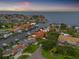 Aerial view of a neighborhood with waterfront homes, boat docks, and canals leading to a large body of water at 1931 Kentucky Ne Ave, St Petersburg, FL 33703