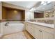 Bathroom featuring double vanity sinks, a soaking tub, and tile flooring at 1931 Kentucky Ne Ave, St Petersburg, FL 33703