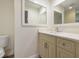 Bathroom vanity with white countertop, cabinetry, and framed mirrors creating a bright and modern space at 1931 Kentucky Ne Ave, St Petersburg, FL 33703