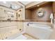 Neutral and elegant bathroom with glass enclosed shower and soaking tub at 1931 Kentucky Ne Ave, St Petersburg, FL 33703