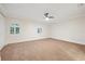Spacious bedroom with carpet, ceiling fan, and arched windows with bright, natural light at 1931 Kentucky Ne Ave, St Petersburg, FL 33703