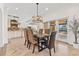 Elegant dining room with modern chandelier and views into the kitchen and backyard at 1931 Kentucky Ne Ave, St Petersburg, FL 33703