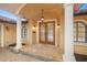 Inviting front entryway featuring a tile roof, white support columns, double doors and stone floors at 1931 Kentucky Ne Ave, St Petersburg, FL 33703