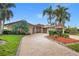 Charming home features a brick driveway and lush tropical landscaping at 1931 Kentucky Ne Ave, St Petersburg, FL 33703