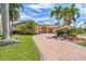 Beautiful, well maintained home with paver driveway, mature landscaping, and manicured lawn at 1931 Kentucky Ne Ave, St Petersburg, FL 33703