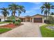 Beautiful single story home featuring a tile roof, double door entryway and a circular brick driveway with lush landscaping at 1931 Kentucky Ne Ave, St Petersburg, FL 33703