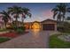 Beautiful home with well-maintained landscaping, a circular driveway, and a two-car garage, showing a luxurious curb appeal at 1931 Kentucky Ne Ave, St Petersburg, FL 33703