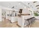 A spacious kitchen boasts cream colored cabinets, pendant lighting, stainless steel appliances, and bar seating at 1931 Kentucky Ne Ave, St Petersburg, FL 33703
