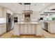 Gourmet kitchen featuring stainless appliances, granite counters, large island, and custom cabinetry at 1931 Kentucky Ne Ave, St Petersburg, FL 33703