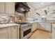 Close up of a kitchen with stainless steel oven, custom tile backsplash, and granite countertops at 1931 Kentucky Ne Ave, St Petersburg, FL 33703