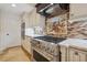Close-up of the range area in the kitchen with stainless steel appliances and decorative backsplash at 1931 Kentucky Ne Ave, St Petersburg, FL 33703