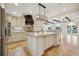 Spacious kitchen with a large center island, granite countertops, mosaic backsplash, and stainless steel appliances at 1931 Kentucky Ne Ave, St Petersburg, FL 33703
