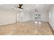 Open living space with tile flooring, neutral paint, modern ceiling fan and sliding glass doors at 1931 Kentucky Ne Ave, St Petersburg, FL 33703