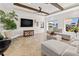 Bright living room featuring exposed beam ceilings, a large television, and stylish decor at 1931 Kentucky Ne Ave, St Petersburg, FL 33703