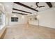 Spacious living room with high ceilings, exposed beams, wet bar, and beautiful tile flooring at 1931 Kentucky Ne Ave, St Petersburg, FL 33703