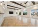Large living room featuring beamed ceilings, multiple windows, and a TV at 1931 Kentucky Ne Ave, St Petersburg, FL 33703