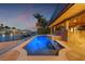 Stunning pool with a spa and outdoor living space overlooking the tranquil waterfront at twilight at 1931 Kentucky Ne Ave, St Petersburg, FL 33703