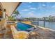Stunning pool and spa combo overlooking the water with boat dock in the background at 1931 Kentucky Ne Ave, St Petersburg, FL 33703