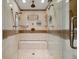 Walk-in shower with glass door, a bench, and multiple shower heads at 1931 Kentucky Ne Ave, St Petersburg, FL 33703