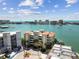 Aerial view of condos by the water with the intercostal in the background offering luxury coastal living at 200 Skiff Pt # 202, Clearwater Beach, FL 33767