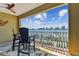 The balcony overlooks a waterfront featuring a seating area and a ceiling fan at 200 Skiff Pt # 202, Clearwater Beach, FL 33767