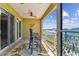 The balcony overlooks a waterfront featuring a seating area and a ceiling fan at 200 Skiff Pt # 202, Clearwater Beach, FL 33767