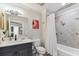 This bathroom offers a combination of classic and modern design, featuring tiled walls, a tub, and vanity at 200 Skiff Pt # 202, Clearwater Beach, FL 33767