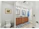 Bright bathroom featuring double sinks with granite countertops and a walk-in shower at 200 Skiff Pt # 202, Clearwater Beach, FL 33767