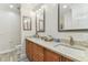 Bathroom featuring a double sink vanity with granite countertops and updated fixtures at 200 Skiff Pt # 202, Clearwater Beach, FL 33767