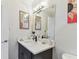 The bathroom features mirrors, a modern light fixture, and a decorative sink that adds to the design at 200 Skiff Pt # 202, Clearwater Beach, FL 33767