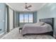 This cozy bedroom with a comfy bed, ceiling fan, and view, provides a relaxing retreat in a stylish setting at 200 Skiff Pt # 202, Clearwater Beach, FL 33767