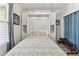 Neutral bedroom with a built-in Murphy bed and wood flooring at 200 Skiff Pt # 202, Clearwater Beach, FL 33767
