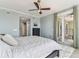 Bedroom featuring a ceiling fan and small table with rug and balcony access at 200 Skiff Pt # 202, Clearwater Beach, FL 33767