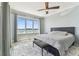 Bedroom featuring a ceiling fan and large window offering views of the beautiful waterfront at 200 Skiff Pt # 202, Clearwater Beach, FL 33767