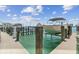 Private boat dock featuring convenient boat lifts at 200 Skiff Pt # 202, Clearwater Beach, FL 33767