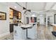 Elegant dining area with a stylish light fixture, four chairs and a decorative rug, adjacent to a bar and open living space at 200 Skiff Pt # 202, Clearwater Beach, FL 33767