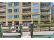 Building exterior showing a dock and waterfront view with multiple balconies and outside ceiling fans at 200 Skiff Pt # 202, Clearwater Beach, FL 33767