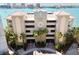 Majestic Point condos exterior featuring a neutral facade, tropical landscaping, and secure gated entrances at 200 Skiff Pt # 202, Clearwater Beach, FL 33767