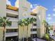 Majestic Point condos exterior featuring a neutral facade, tropical landscaping, and secure gated entrances at 200 Skiff Pt # 202, Clearwater Beach, FL 33767