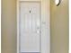 Neutral-colored front door with secure access and a modern doorbell for added security at 200 Skiff Pt # 202, Clearwater Beach, FL 33767