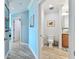 Hallway with a bathroom featuring a vanity and toilet and beautiful wooden floors at 200 Skiff Pt # 202, Clearwater Beach, FL 33767