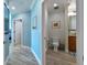 Hallway with a bathroom featuring a vanity and toilet and beautiful wooden floors at 200 Skiff Pt # 202, Clearwater Beach, FL 33767
