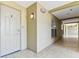 Hallway and apartment entrance showcasing tiled flooring and a white front door at 200 Skiff Pt # 202, Clearwater Beach, FL 33767