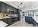 Open-concept kitchen with gray cabinets, stainless steel appliances, and expansive island at 200 Skiff Pt # 202, Clearwater Beach, FL 33767