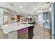 Spacious kitchen with large center island, stone countertops, modern appliances, and wood-look tile at 200 Skiff Pt # 202, Clearwater Beach, FL 33767