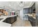 Modern kitchen with a large island, stainless steel appliances, dark cabinetry, and open layout leading to other living areas at 200 Skiff Pt # 202, Clearwater Beach, FL 33767